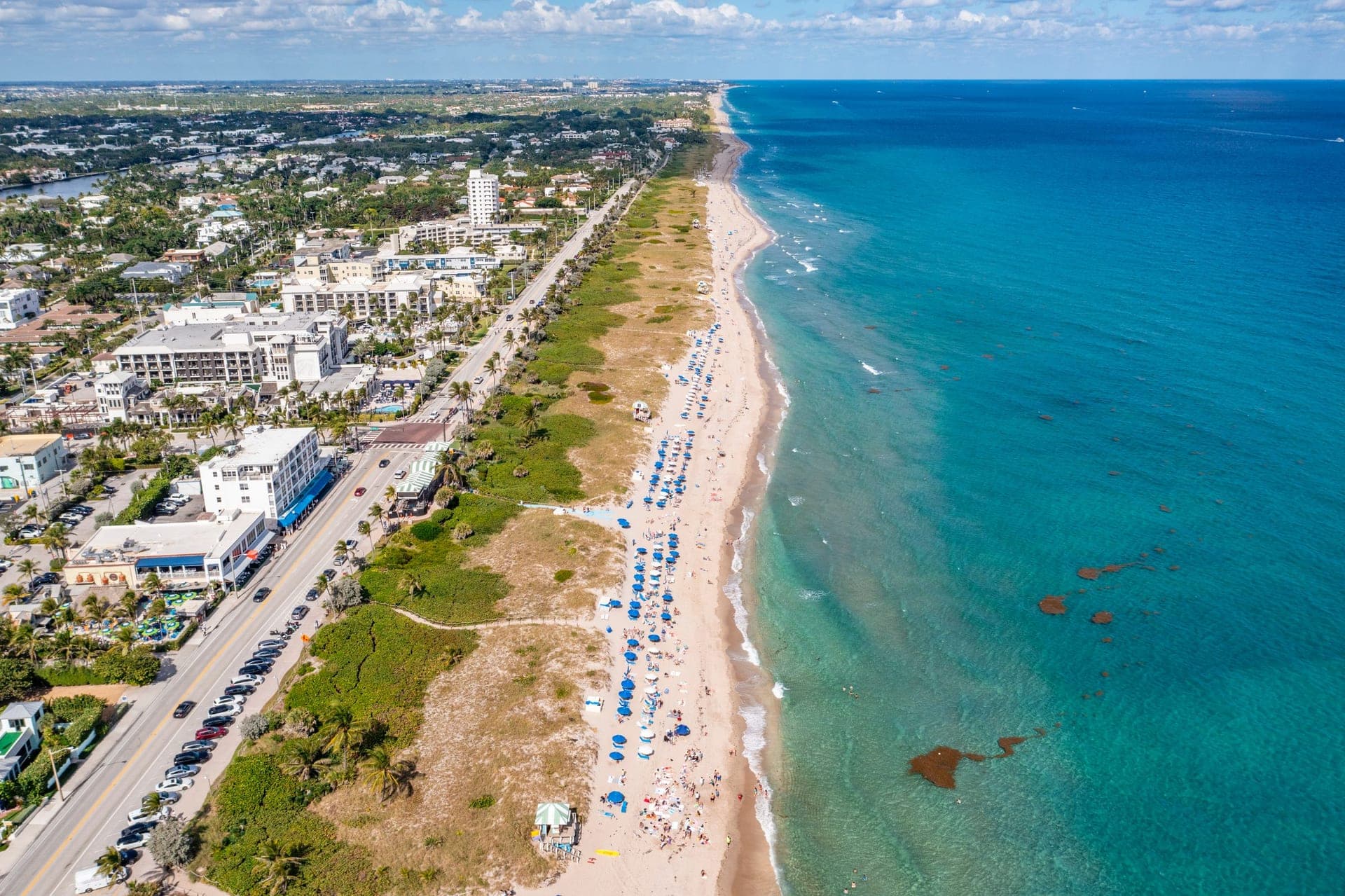 Sweeping aerial of the Intracoastal inlet with yachts and waterfront properties