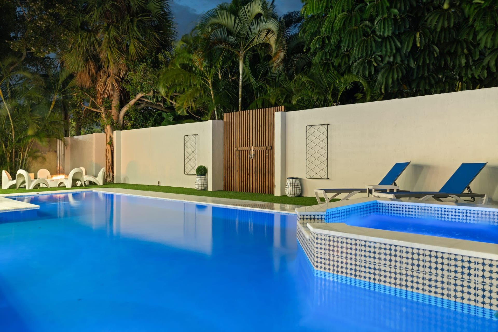 Pool-level view with mosaic-tiled spa and lush tropical landscaping